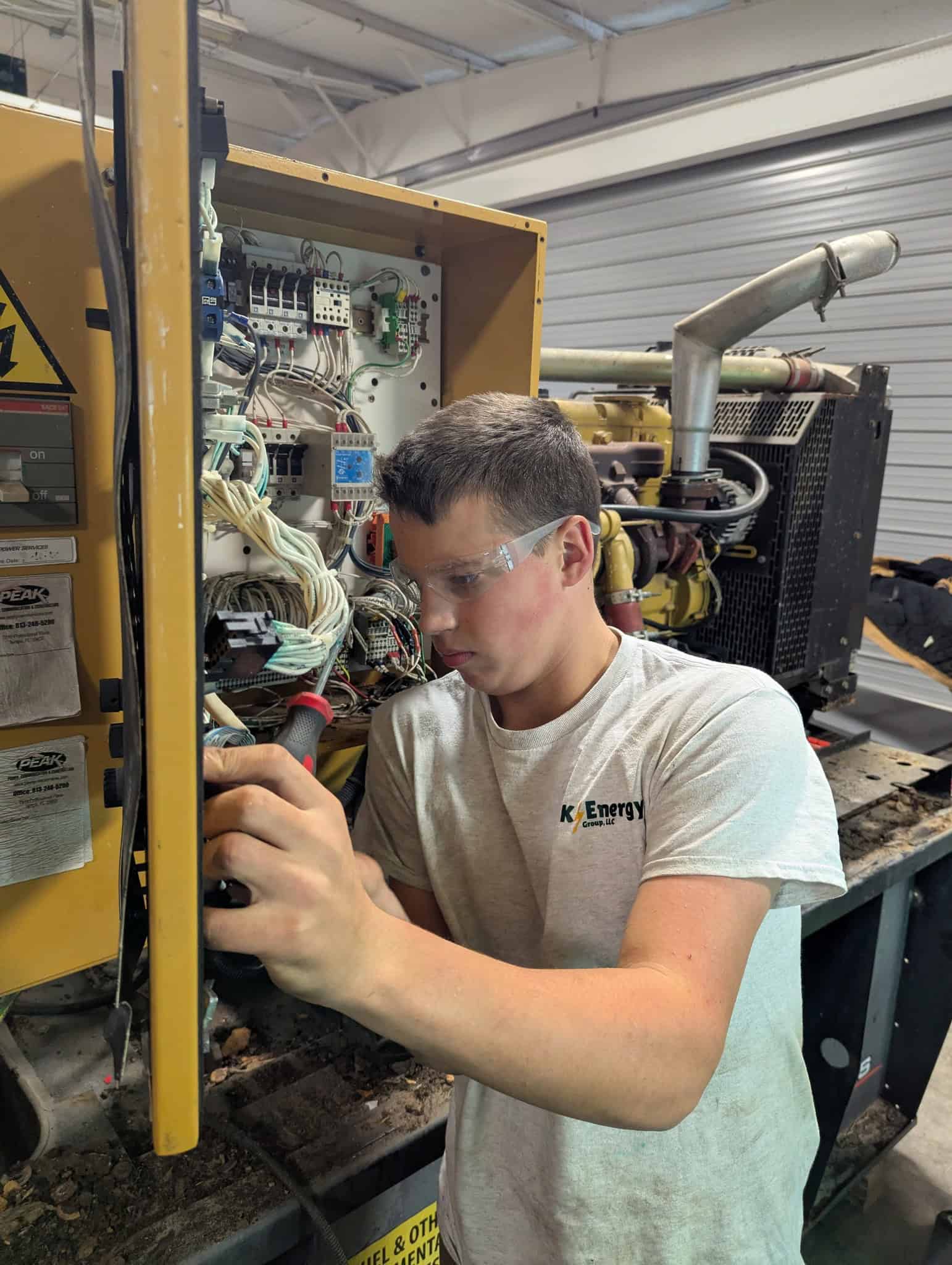 Skilled technician repairing or refurbishing a commercial generator's electrical systems.